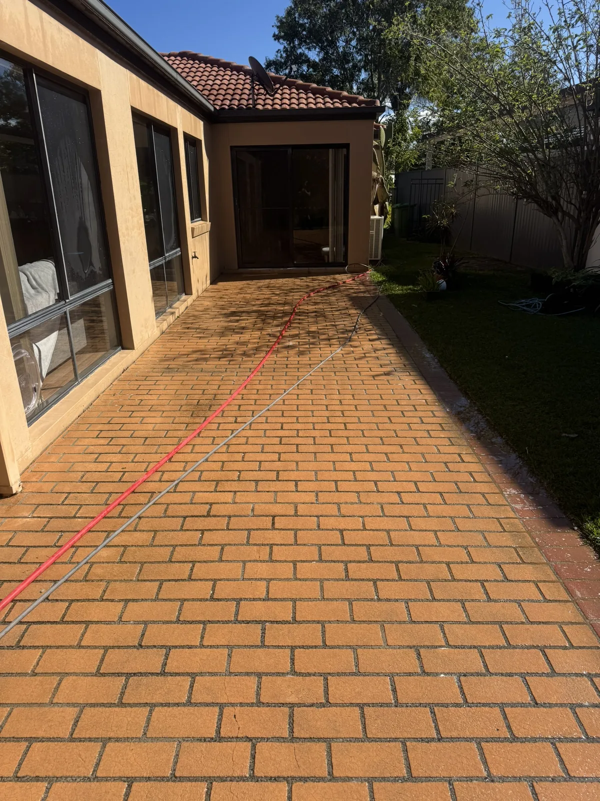 Outdoor pavers cleaned and refreshed after pressure cleaning — after
