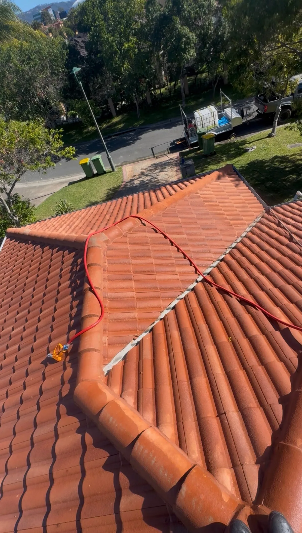 Terracotta roof hips and valleys restored to vibrant red — after
