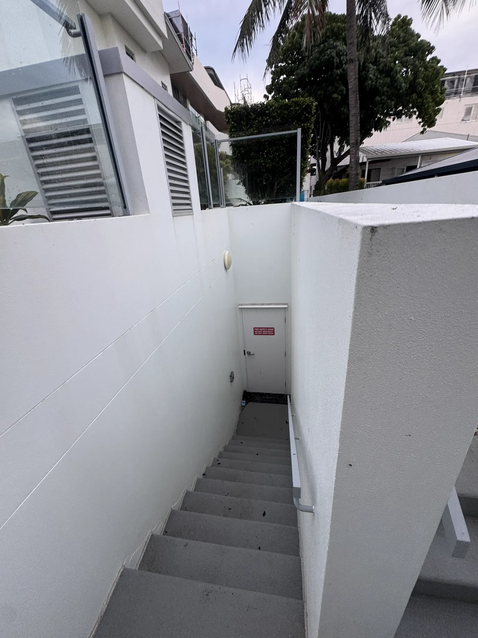 Clean white stairwell and walls after soft wash treatment — after